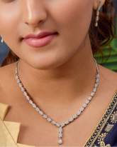 Woman wearing a diamond necklace with a blurred background