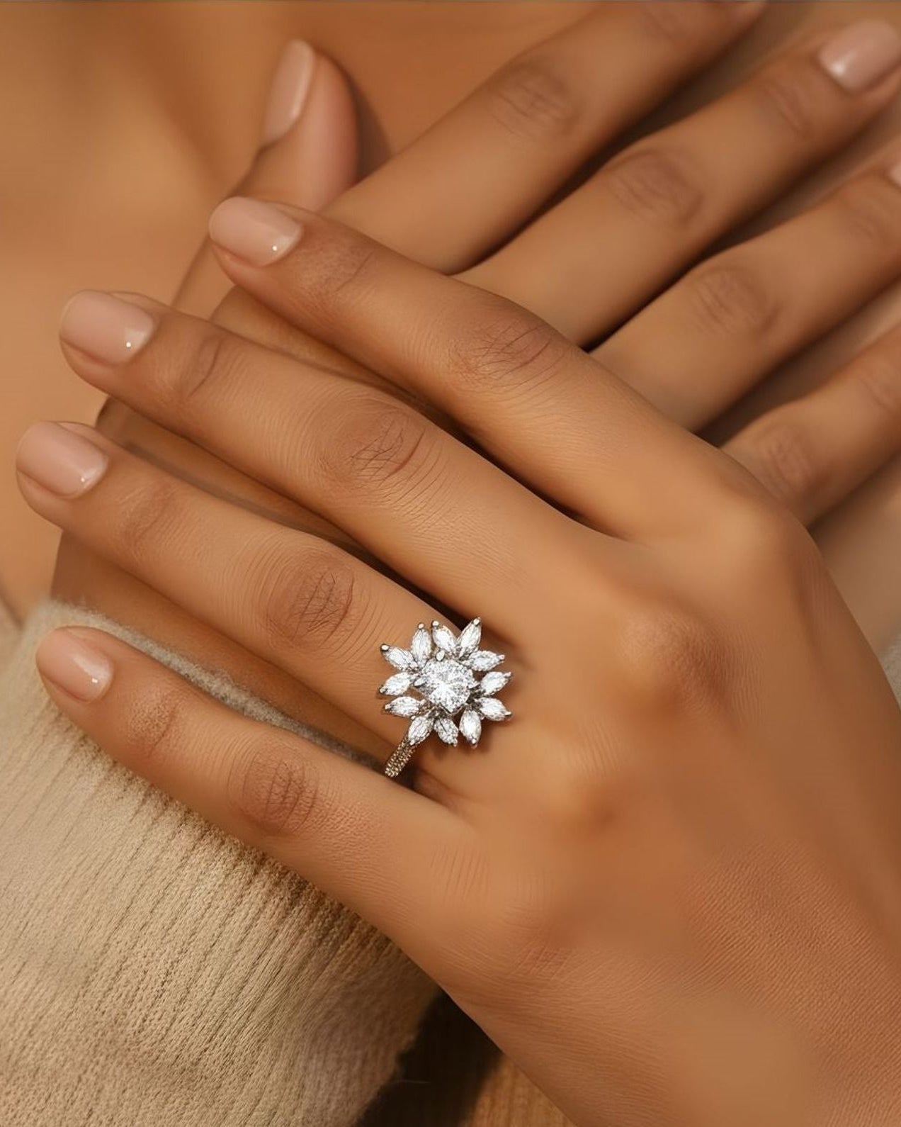 Hand wearing a diamond ring with a blurred background