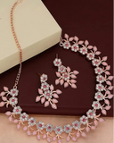 Jewellery set with necklace and earrings on a brown background, featuring the Brado Jewellery brand.