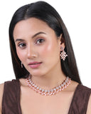 Woman wearing a necklace and earrings on a white background