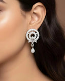 Close-up of a woman wearing a diamond earring with a neutral background