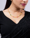 Woman wearing a black saree with a plain background