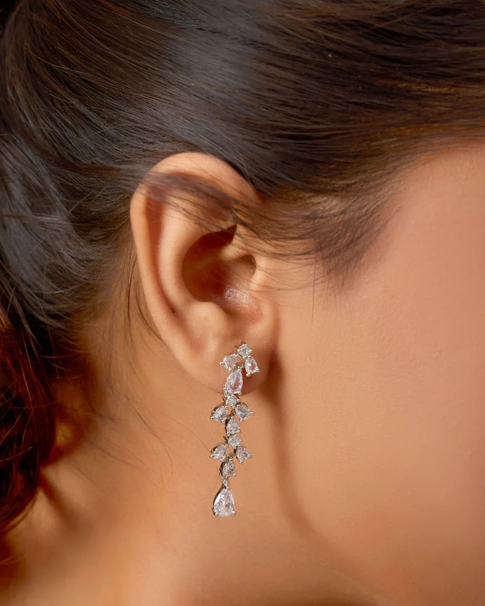 Close-up of a woman wearing a silver earring with a blurred background