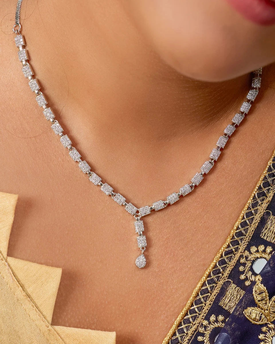 Close-up of a diamond necklace worn by a person with a traditional outfit.