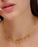 Gold necklace with pendant on a person's neck
