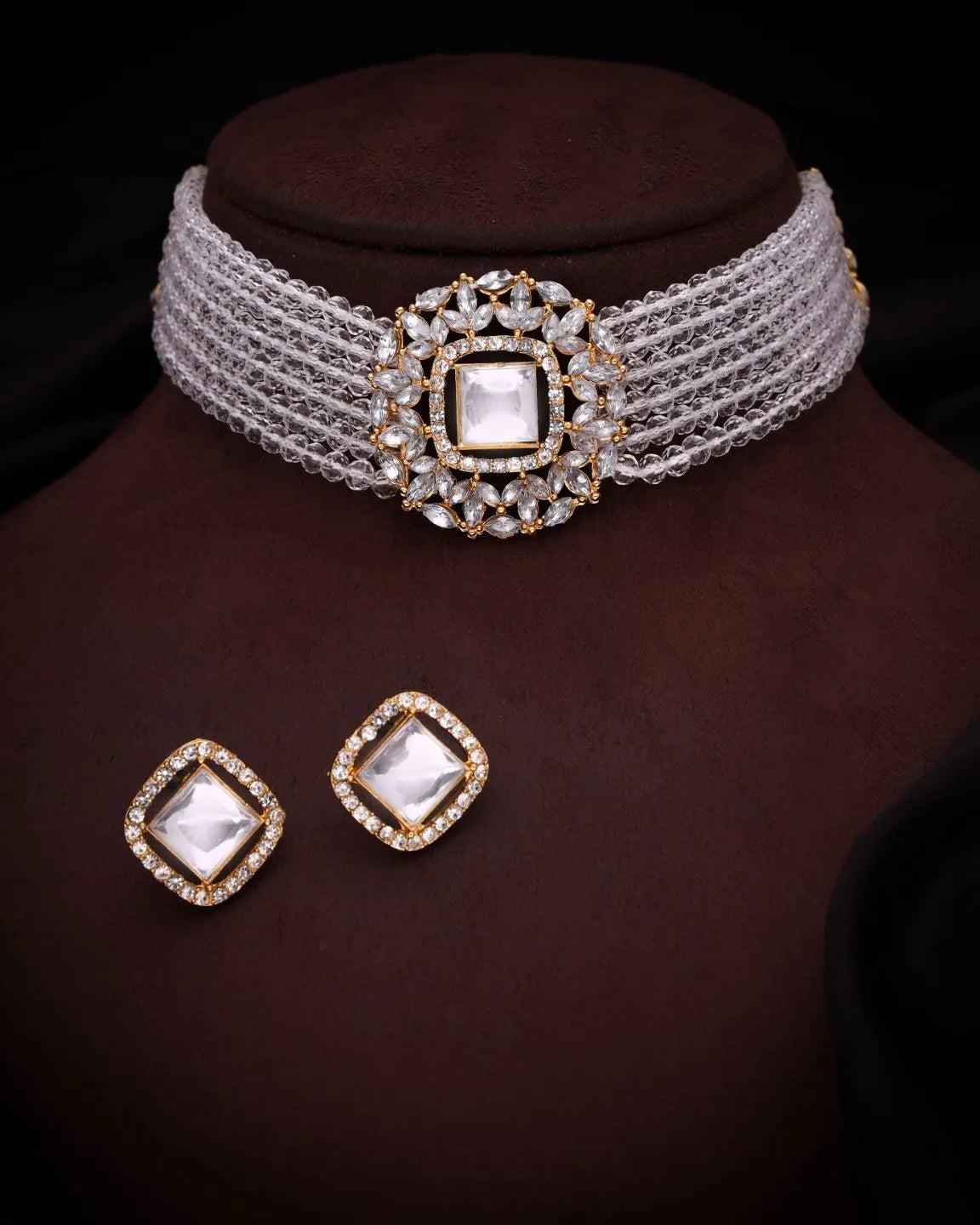 Jewelry set with a choker and earrings on a brown stand